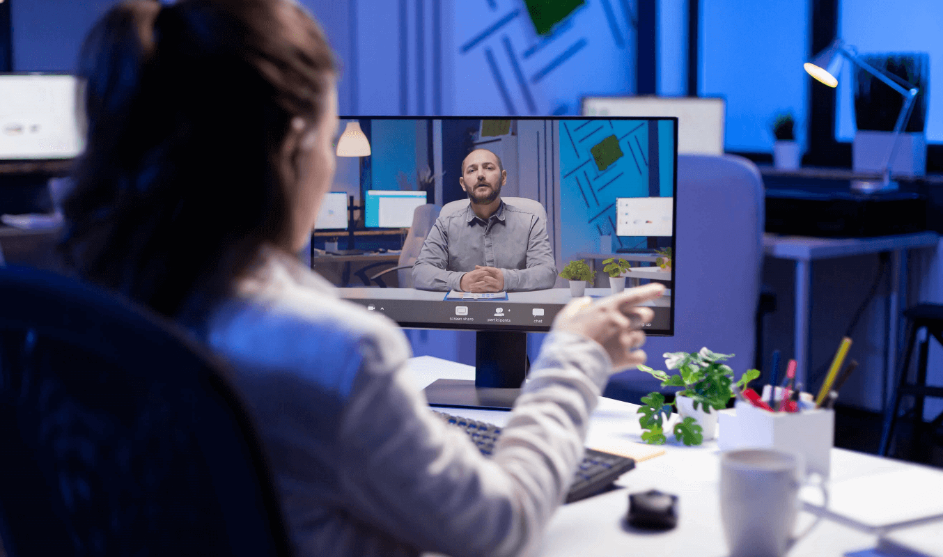 A female staff discussing with her team mates via video conferencing